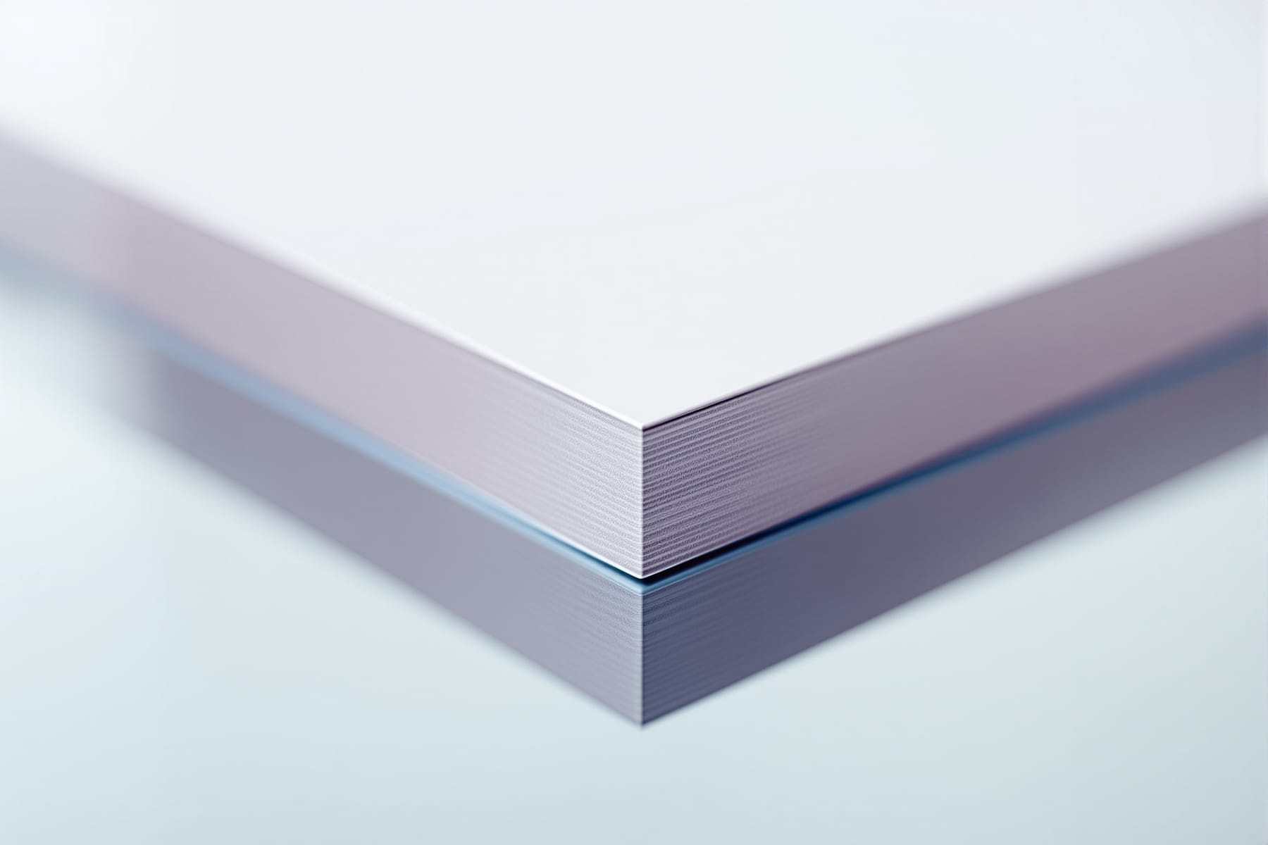 A card edge meeting its reflection with no gap, the test for a first-surface mirror