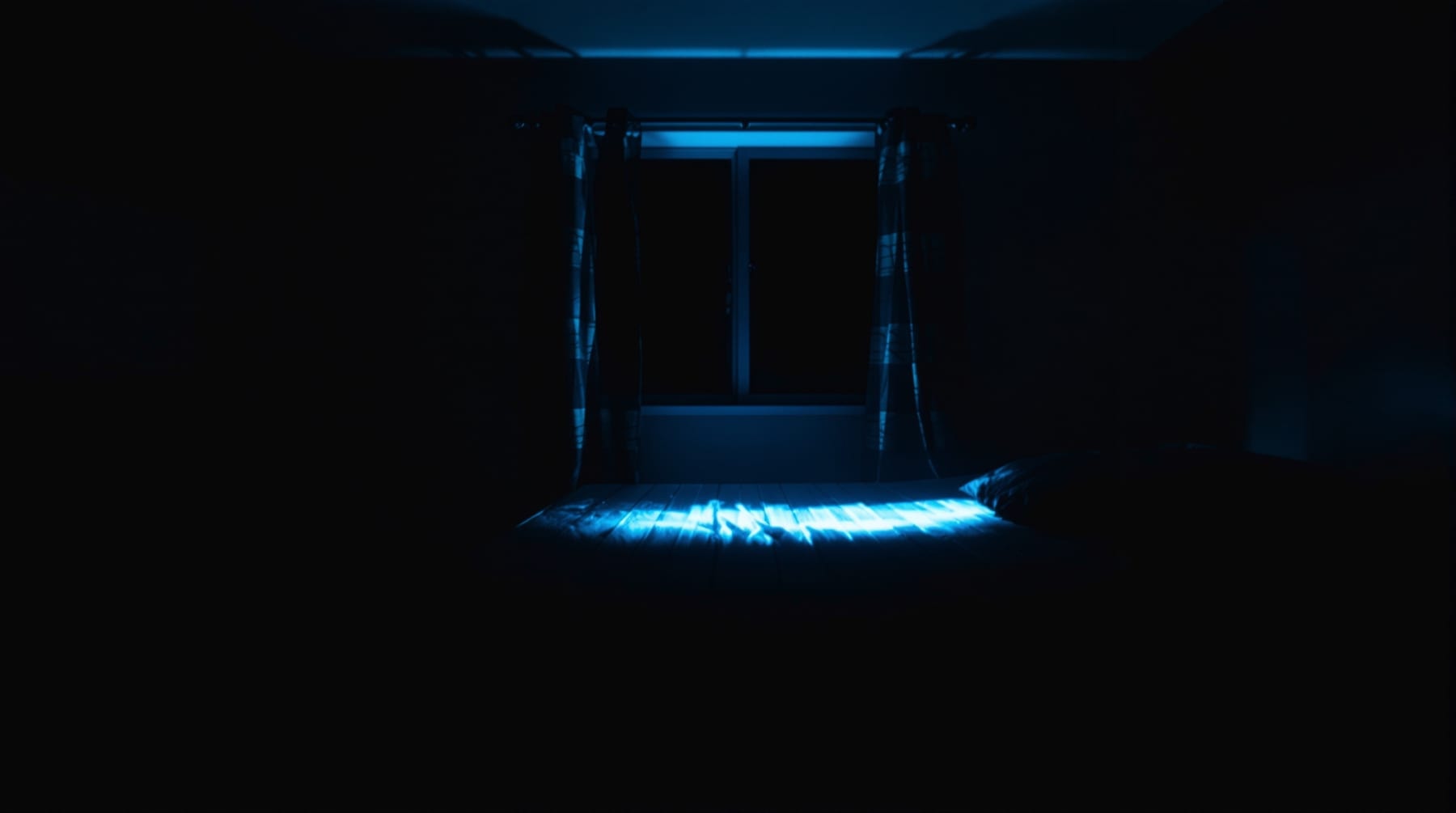 Cold street light spilling through a bedroom window and across a bed at night