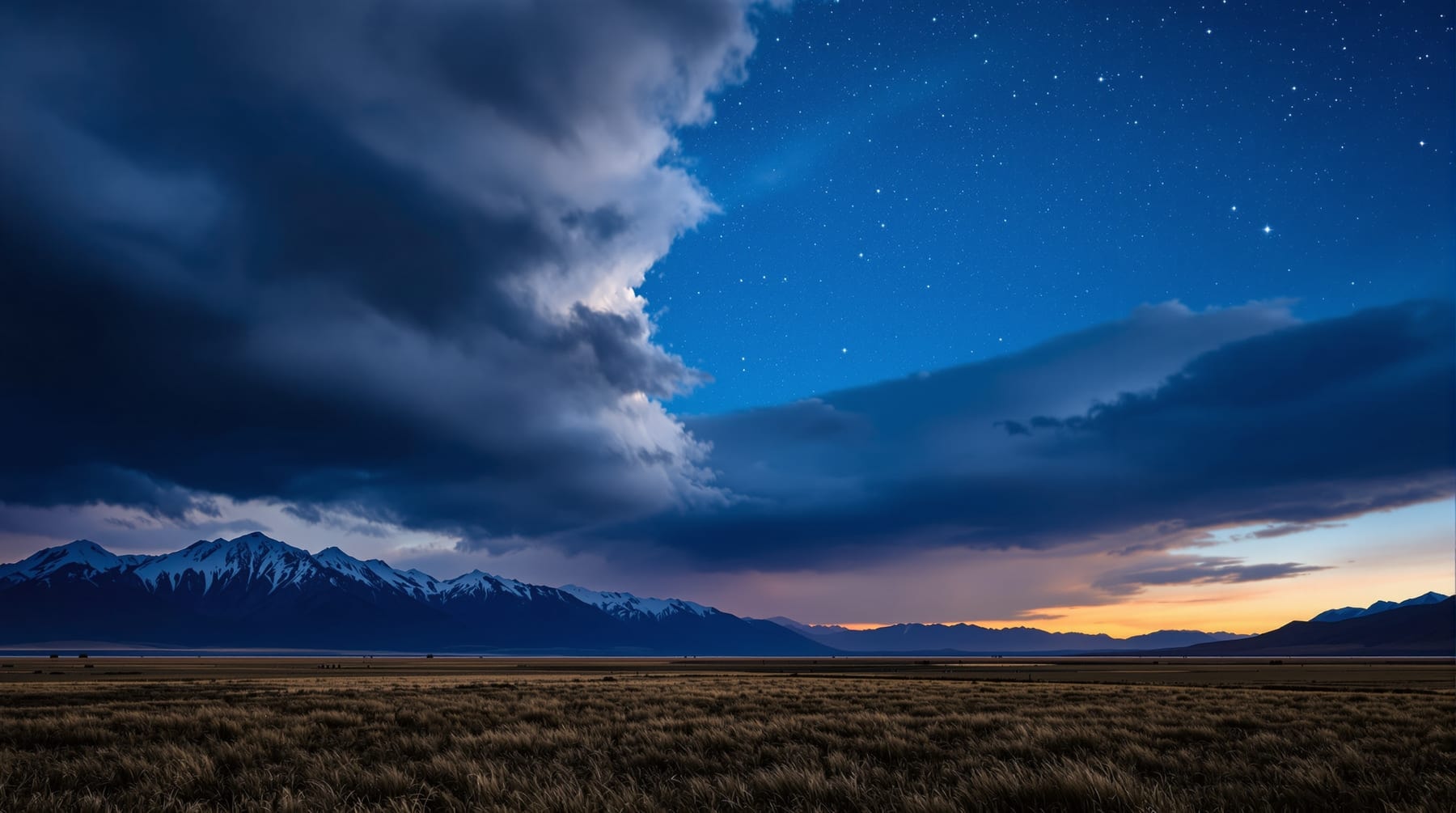 A weather front clearing off a valley leaving hard clear sky and early stars