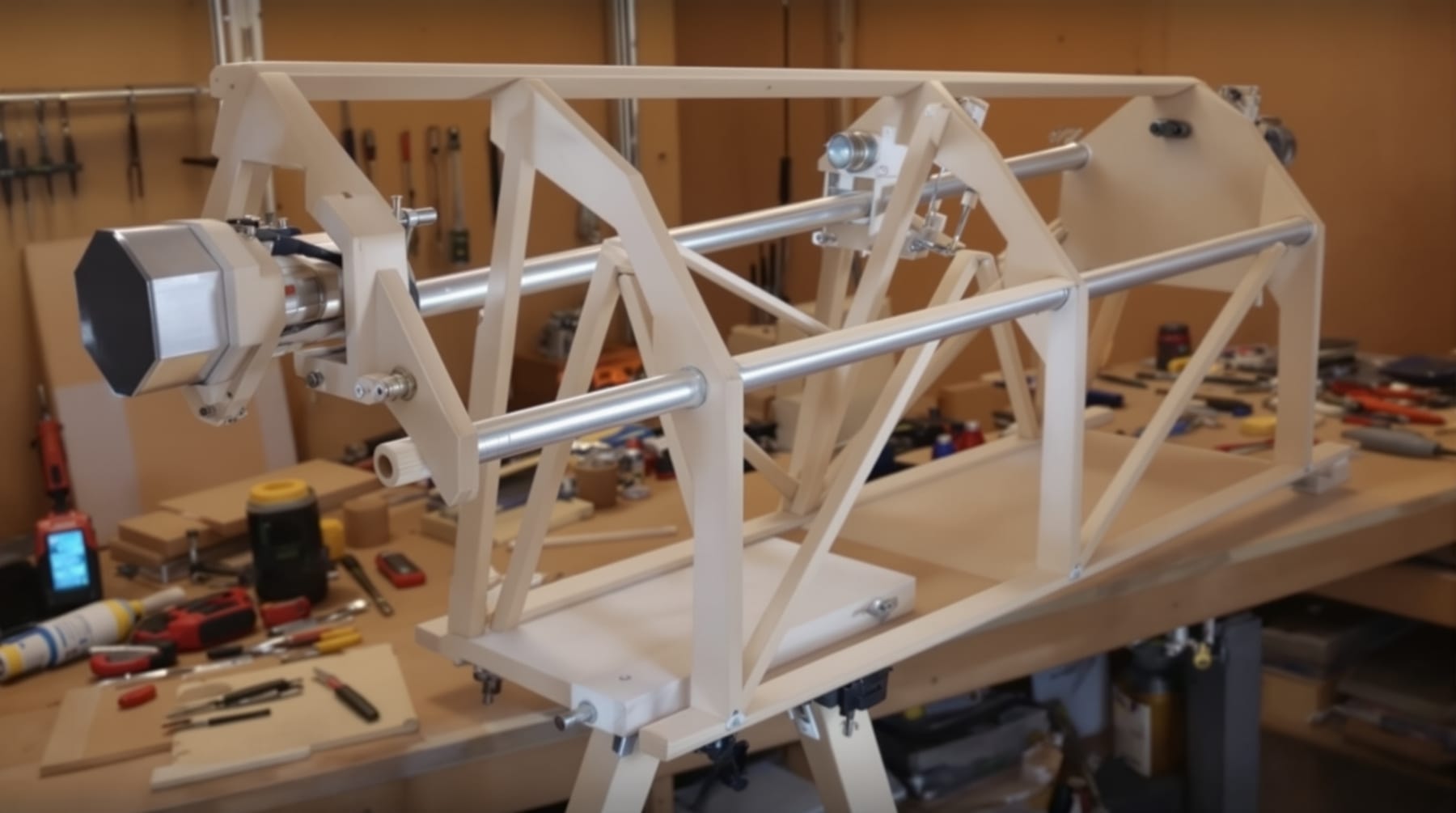 A partly finished home-built plywood truss Newtonian telescope in a workshop