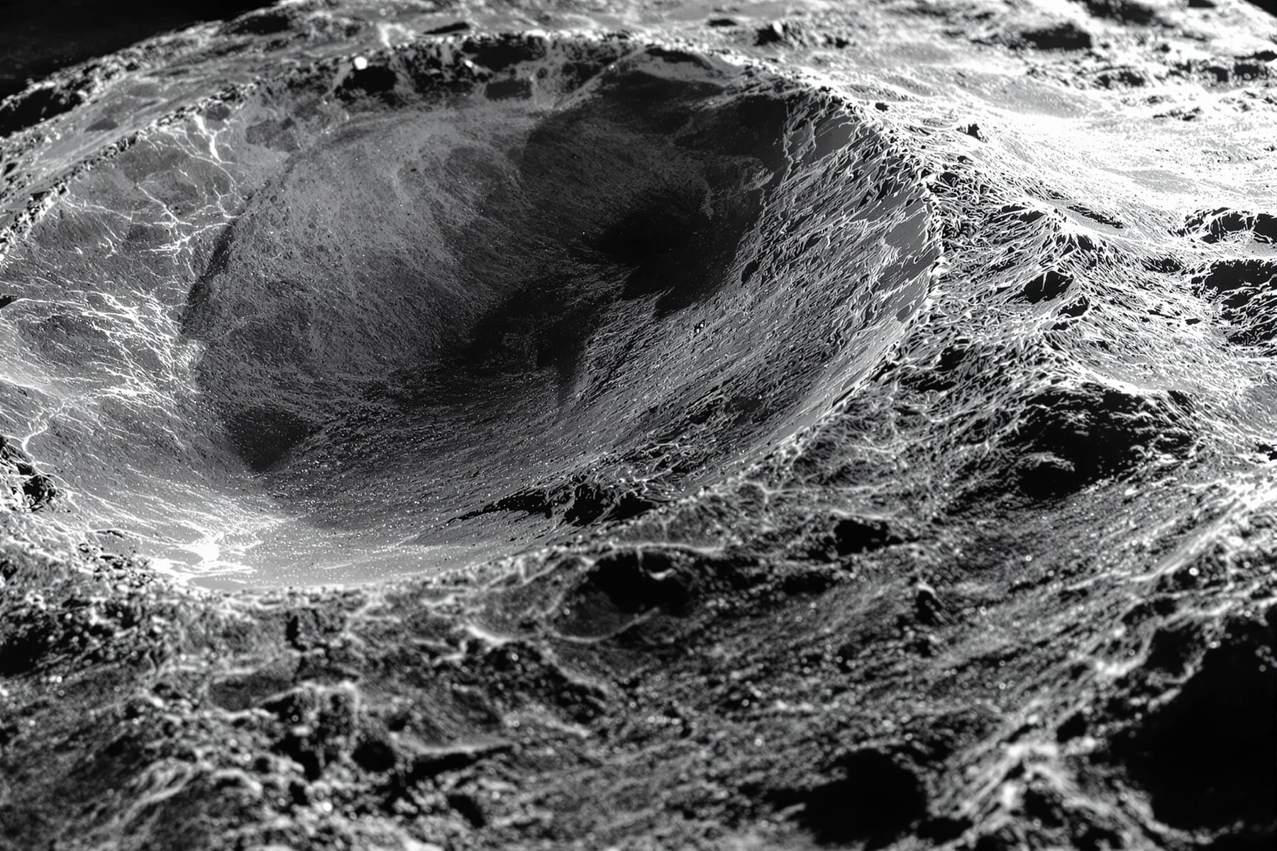 A mirror face under knife-edge test showing shadows like a relief landscape